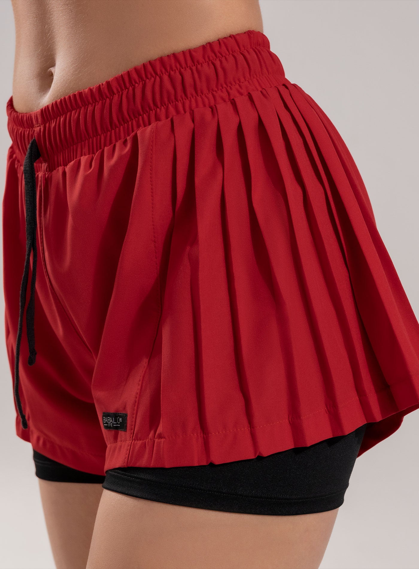 SHORT DEPORTIVO CON DISEÑO PLISADO Y SHORT INTERNO